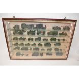 Collection of Dinky armour models (and some Solido) with a wall mounted display case