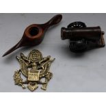 Moneybox cannon model, makers name Banthrico Inc. USA, brass US military crest wall plaque and a