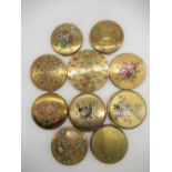 Four Stratton compacts with floral prints on metal ground, Kigu compact with floral print on metal