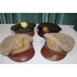 Four US airforce peaked caps with brass badges, brown leather peak, two khaki one chocolate and