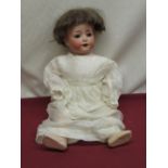 Heubach Koppelsdorf bisque headed doll model 321.0 wearing brown wig and silk dress, H43cm