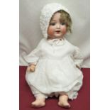 Armand Marseille bisque headed doll model 996, wearing curly blonde wig, crochet bonnet, white