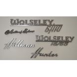 Five vintage chromed car manufacturers signs including Wolsey 6/110, Hillman Hunter, Austin of