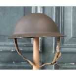 WWII British brodie helmet with paintwork and inner liner, with camouflage netting