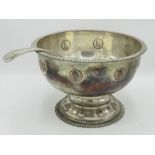 Early C20th silver plated punch bowl, with gadrooned edge, set with coins, circular pedestal foot
