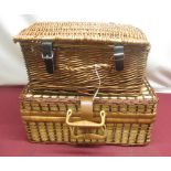 Wicker picnic basket with checked interior, a set of four plastic plates, mugs and cutlery and