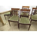 Set of four Regency style mahogany dining chairs with pierced splat and drop in seats on fluted