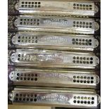 Six Hohner 's Best Harmonicas and a similar smaller harmonica