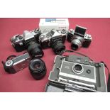 A box of various cameras including an Edixa Prismaflex, Canon Ixus L-1, Polaroid 340 etc