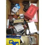 Box of various camera accessories including light meters, lens hoods, flash guns, slide duplicator