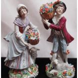 Pair of C20th Sitzendorf porcelain figures of lady and gentlemen flower sellers, each wearing