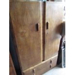 Art Deco figured walnut gentlemen's wardrobe, with two doors and part fitted interior above two