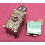 Coronet Midget camera in brown marble finish with two spare reels.