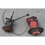 Two vintage manual gearboxes (possibly motorbike gearboxes), orange one with no makers marks, the