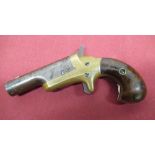 Colt Derringer pistol with brass frame and two piece wooden grip