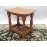 Robert Mouseman Thompson of Kilburn - an oak joint type stool, adzed dished top on octagonal