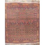 Caucasian wool red ground rug, with central pattern field, surrounded by floral pattern border, 95cm