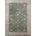 Herez pattern rug, central green ground field set with sylised floral motifs surrounded by beige