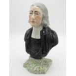 C19th head and shoulder bust of Rev. John Wesley in clerical robes, on a shaped marbled plinth, with