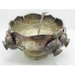 C20th EPNS circular punch bowl with garlands of repousse flowers, shaped gadrooned rim and lion mask