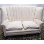 Edwardian upholstered sofa with pleated high wing back, outscrolled arms and two loose seat cushions