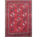 Caucasian pattern rust ground rug, central field with twelve octagonal geometric pattern roundels,