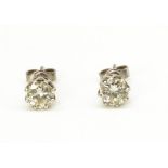Pair of diamond stud earrings, round cut diamonds, claw set in white metal mounts, approx. 0.50mm,