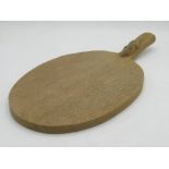 Robert Mouseman Thompson of Kilburn - an adzed oak oval cheese board, curved handle carved with