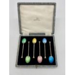Cased set of six ERII hallmarked sterling silver seal top coffee spoons with multicolored enamel
