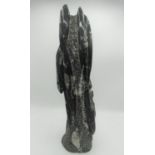 Carved black sculpture of Ammonoids and Orthocara fossils