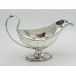 Geo.V hallmarked sterling silver gravy boat, on oval stepped pedestal base initialed W, by