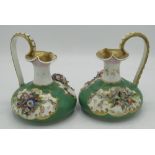 Pair of Bloor Derby ewers, encrusted with flowers in reserve panels on an apple green ground, with