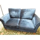 Art Deco style blue velour upholstered sofa, with out-scrolled arms and loose back and seat cushions