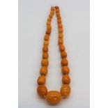 Butterscotch amber necklace, single row of graduated oval beads, largest approx. 2.5cm, overall