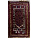Kayam red and antque gold ground wool rug with central field and stylised alternating geometric