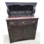 C18th and later oak court type cupboard, three earlier panelled back carved with stylised foliage