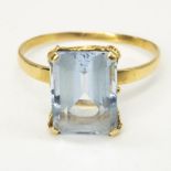 18ct yellow gold aquamarine ring, emerald cut aquamarine claw set in a looped chain effect mount,