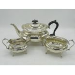 Geo.V hallmarked sterling silver three piece tea service, tea pot with ebonised handle and final,