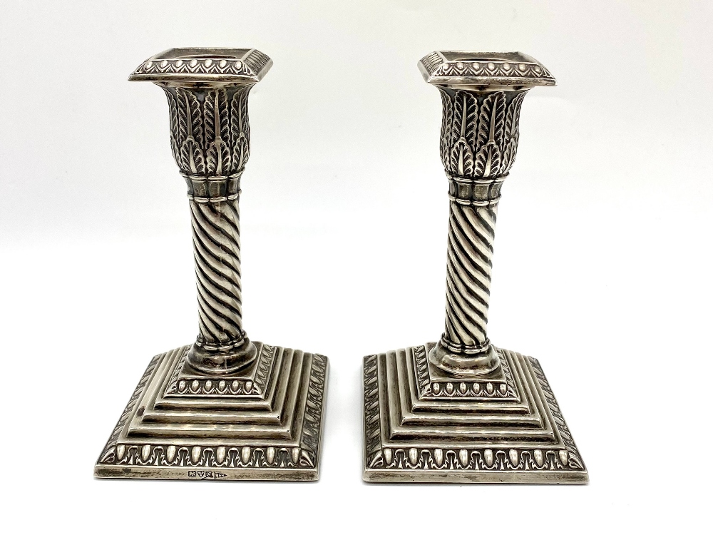 Pair of small Edw.VII hallmarked sterling silver candlesticks, lobed acanthus sconces on wrythen