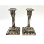 Pair of small Edw.VII hallmarked sterling silver candlesticks, lobed acanthus sconces on wrythen