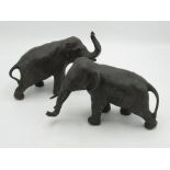 Pair of small Japanese hollow patinated bronze models of elephants with bronze tusks, both standing,