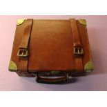 Tan leather cartridge box with brass reinforced corners, with lined and fitted four sectional