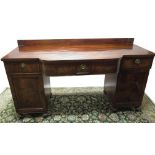 Regency mahogany bow breakfront pedestal sideboard, low raised back and three frieze drawers with