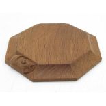 Robert Mouseman Thompson of Kilburn - an oak octagonal tea pot stand, carved with signature mouse,