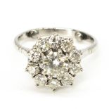 Diamond daisy ring, round cut, claw set diamond surrounded by ten smaller claw set round cut,