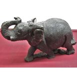 Large carved stone model of an elephant, standing with curled trunk, L50cm H30cm