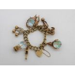 9ct yellow gold charm bracelet including carriage, trumpet, thrown, clown, hot air balloon, teapot