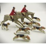 C1920s-1930s hand carved wooden hunt group including two horses, two riders and seven dogs (possibly