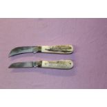 Pair of Samba horn handled pocket knives, 1 a pruner, the other a Lambfoot. Both 8cm blades, overall