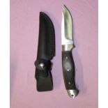 A boxed as new Whitby stainless steel skinning knife, full tang and 2 piece wooden handle and